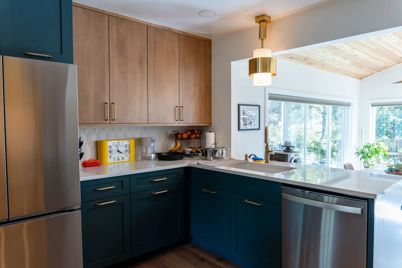 Updated kitchen connected to a bright custom sunroom living area