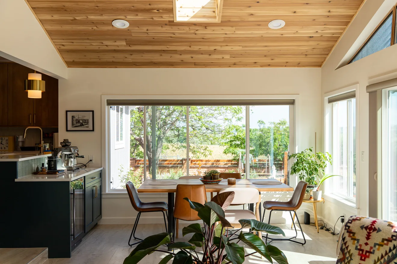 Wide interior view showing the kitchen connection to the new sunroom and living space