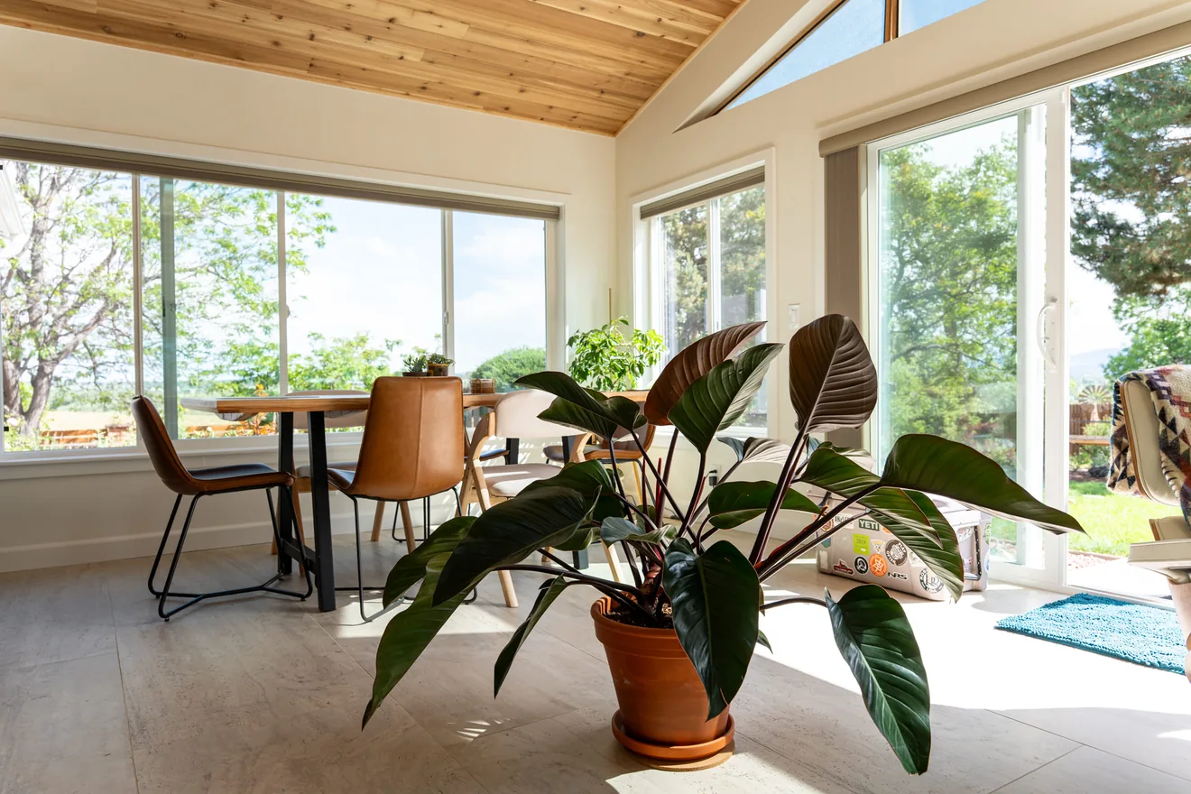 Window-filled dining area in the completed sunroom addition