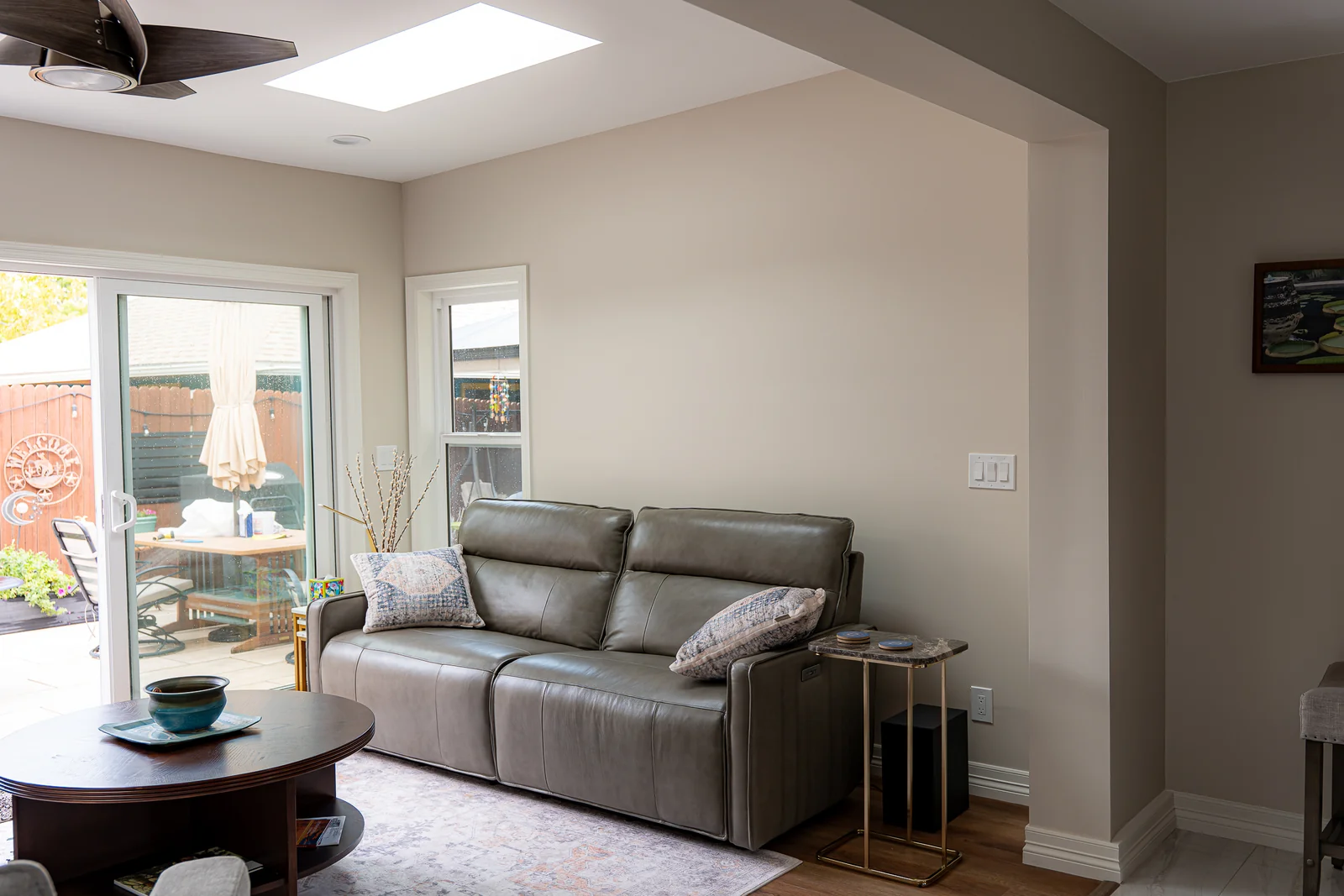Sofa and seating area beside the sliding glass door in the Englewood sunroom