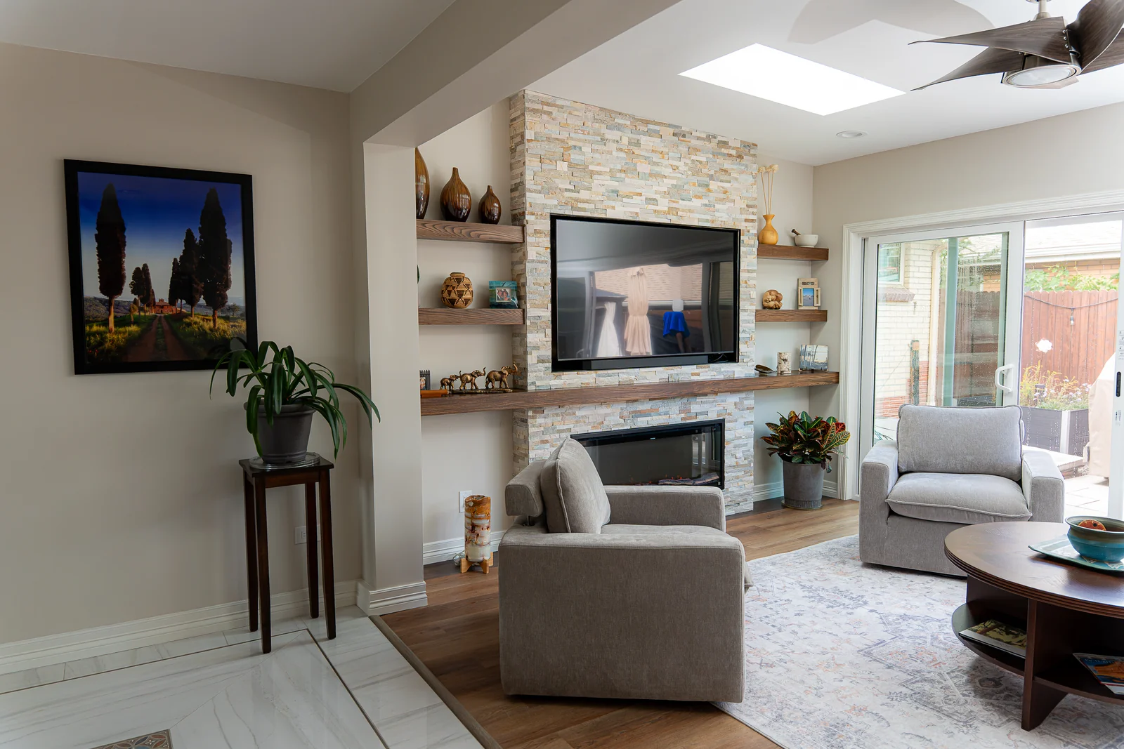Skylights above the finished sunroom with a fireplace and sliding glass door
